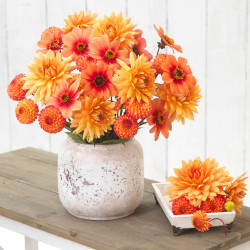 A tabletop bouquet of single, ball and dinnerplate dahlias in a harmony of orange and gold hues.