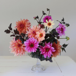 A festive floral arrangement of dahlias in hues of pink, peach and melon, featuring the varieties Fascination Belle of Barmera, HS Date and Labyrinth.