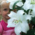 Oriental lily Casa Blanca with a young child behind one of the enormous, pure-white flowers to provide scale.